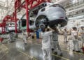 Workers on the assembly line at the Zhejiang Leapmotor Technology Co. production facility in Jinhua, Zhejiang province, China, on Sunday, June 23, 2024. Chinese electric car maker Leapmotor is little known outside its home country, and even there it is overshadowed by bigger players like BYD Co. and Tesla Inc. Photographer: Qilai Shen/Bloomberg