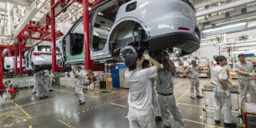 Workers on the assembly line at the Zhejiang Leapmotor Technology Co. production facility in Jinhua, Zhejiang province, China, on Sunday, June 23, 2024. Chinese electric car maker Leapmotor is little known outside its home country, and even there it is overshadowed by bigger players like BYD Co. and Tesla Inc. Photographer: Qilai Shen/Bloomberg