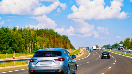 Cars on road on sunny day