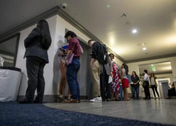 Attendees wait in line to enter a hiring event in Sacramento, California.