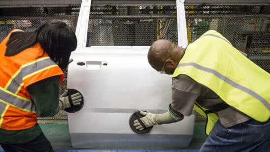 Employees scuff a door on the production line an assembly plant in Arlington, Texas. Photographer: Matthew Busch/Bloomberg