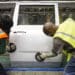 Employees scuff a door on the production line an assembly plant in Arlington, Texas. Photographer: Matthew Busch/Bloomberg