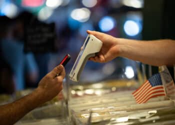 A customer uses a smartphone to pay for a purchase in Seattle.