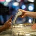 A customer uses a smartphone to pay for a purchase in Seattle.