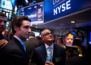 Ernie Garcia III, founder and chief executive officer of Carvana Co., second left, and his father Ernest Garcia II, chairman of Carvana Co., center, stand during the company's initial public offering (IPO) on the floor of the New York Stock Exchange (NYSE) in New York, U.S., on Friday, April 28, 2017. U.S. stocks remained near record highs, Treasuries dropped and oil closed in on $50 a barrel even after the world's biggest economy reported its slowest pace of expansion in three years.