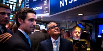 Ernie Garcia III, founder and chief executive officer of Carvana Co., second left, and his father Ernest Garcia II, chairman of Carvana Co., center, stand during the company's initial public offering (IPO) on the floor of the New York Stock Exchange (NYSE) in New York, U.S., on Friday, April 28, 2017. U.S. stocks remained near record highs, Treasuries dropped and oil closed in on $50 a barrel even after the world's biggest economy reported its slowest pace of expansion in three years.