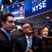 Ernie Garcia III, founder and chief executive officer of Carvana Co., second left, and his father Ernest Garcia II, chairman of Carvana Co., center, stand during the company's initial public offering (IPO) on the floor of the New York Stock Exchange (NYSE) in New York, U.S., on Friday, April 28, 2017. U.S. stocks remained near record highs, Treasuries dropped and oil closed in on $50 a barrel even after the world's biggest economy reported its slowest pace of expansion in three years.