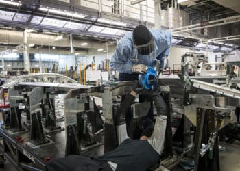 Workers assemble the Lucid Air prototype electric vehicle, manufactured by Lucid Motors Inc., at the company's headquarters in Newark, California, U.S., on Monday, Aug. 3, 2020. The final specs and design of the Lucid Air are due to be unveiled at an event in September and executives say customers can now expect delivery of the first batch of Airs in spring 2021.