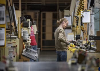 A worker assembles window frames at a manufacturing facility in Pella, Iowa. Photographer: Sergio Flores/Bloomberg
