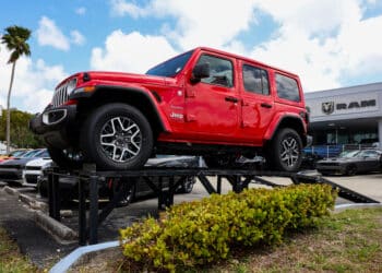 A Jeep Wrangler for sale at a dealership in Miami.