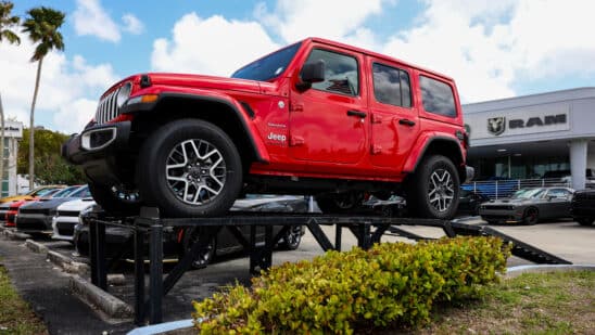 A Jeep Wrangler for sale at a dealership in Miami.