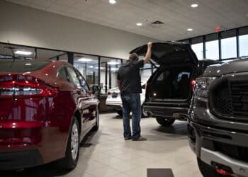 A customer looks over a vehicle at a car dealership in Orland Park, Illinois.