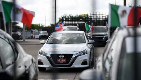 Mexican and American flags on vehicles at a Tricolor dealership in Houston, Texas. Photographer: Mark Felix/Bloomberg