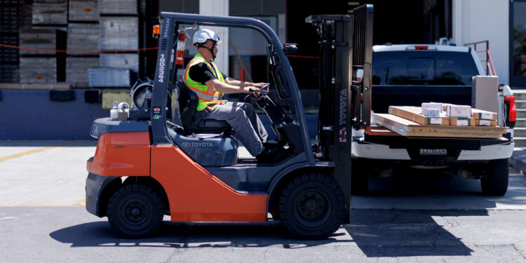 A worker drives a forklift outside a Foundation Building Materials warehouse in Los Angeles, California, US, on Wednesday, Aug. 20, 2025. Lowes Cos. agreed to buy Foundation Building Materials for about $8.8 billion in cash, accelerating the home-improvement supplier's push to serve more professional customers. Photographer: Eric Thayer/Bloomberg