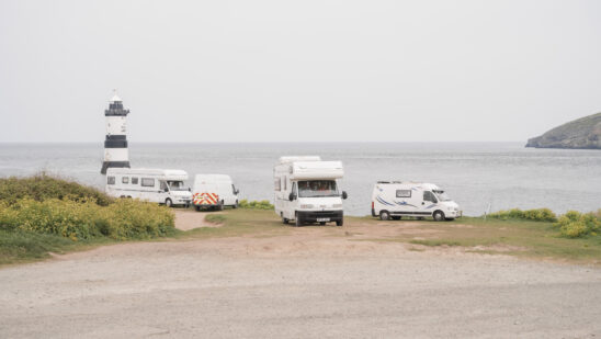 Campervans and motorhomes parked at Penmon Point in Anglesey, UK, on Saturday, April 30, 2022. Anglesey is where the government's new energy strategy and its economic vision meet, but some locals are skeptical.