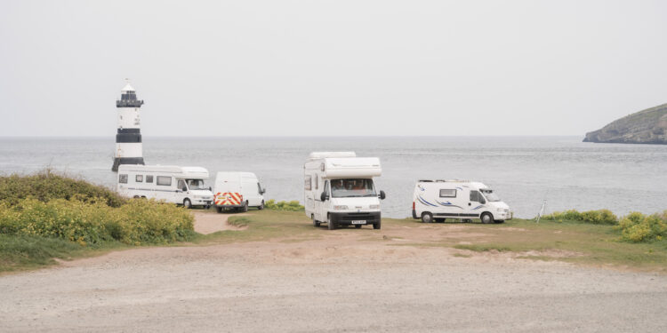 Campervans and motorhomes parked at Penmon Point in Anglesey, UK, on Saturday, April 30, 2022. Anglesey is where the government's new energy strategy and its economic vision meet, but some locals are skeptical.