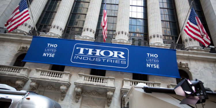 Thor Industries Inc. signage hangs below American flags outside the New York Stock Exchange (NYSE) in New York, U.S., on Monday, Aug. 29, 2016. U.S. stocks rose, halting the longest slide since June, as an increase in consumer spending last month bolstered confidence in the economy and a drop in Treasury yields sparked demand for equities with rates of dividend payouts.