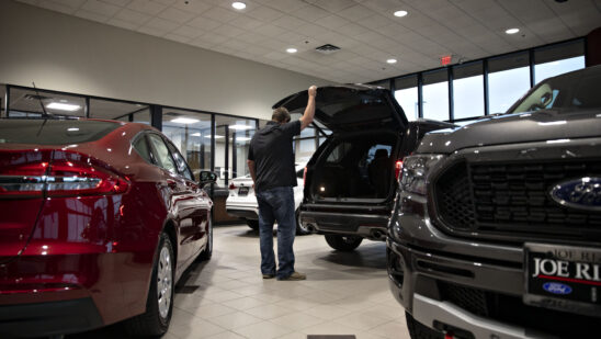 A customer looks over an SUV at a car dealership in Orland Park, Illinois.
