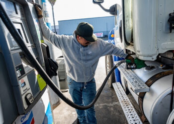 A driver refuels a tractor trailer at a truck stop in Tracy, California.