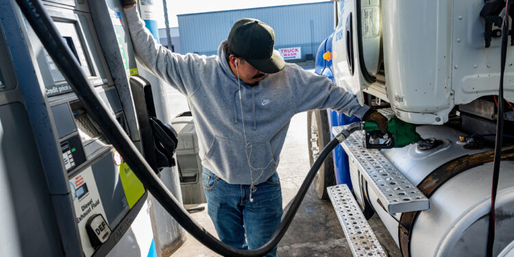 A driver refuels a tractor trailer at a truck stop in Tracy, California.