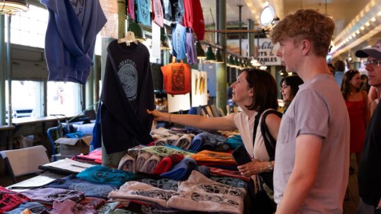 A customer looks at clothing for sale at the Pike Place Market in Seattle.