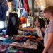 A customer looks at clothing for sale at the Pike Place Market in Seattle.